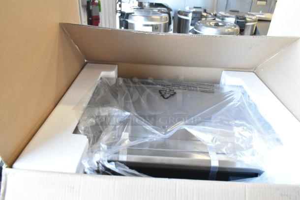 Brand new Oster stainless steel convection oven in original packaging, unopened and wrapped in protective plastic.