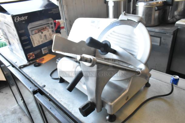 Globe G12 metal commercial countertop meat slicer with blade sharpener, 115 volts, 1 phase, shown on metal surface.