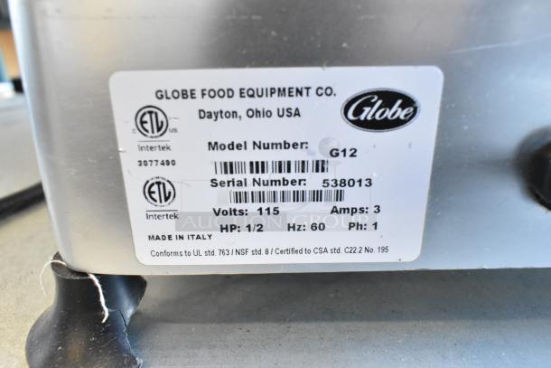 Globe G12 metal commercial meat slicer with blade sharpener, 115 volts, 1 phase, serial number 538013, made in Italy.