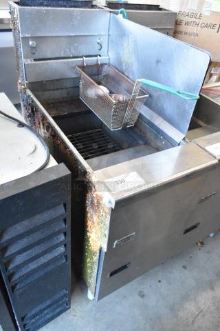 Pitco Frialator SG14 stainless steel commercial gas fryer with metal fry basket and side splash guard, 110,000 BTU.
