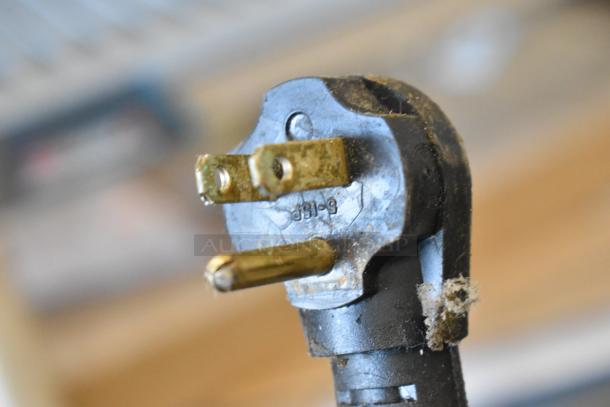 Three-pronged electrical plug for Imbera VR06 cooler, condition shows wear, labeled with manufacturing markings.