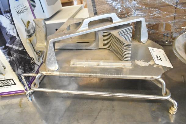 Metal countertop tomato slicer with sturdy blades and handle, visible wear, mounted on a metal stand, auction tag number 336.