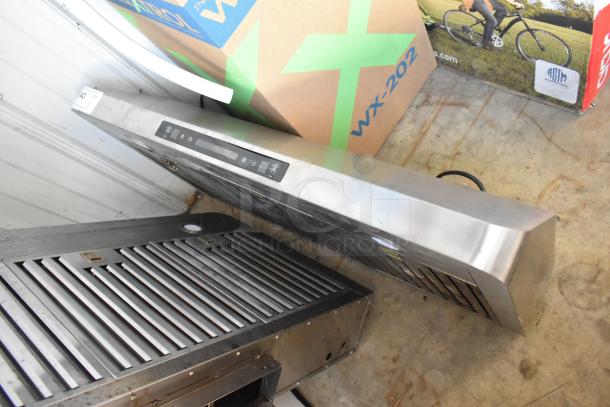 Stainless steel range hood with control panel, modern design. Appears in good condition with slight surface marks.