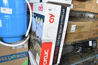 Brand new Cyclic Double 2-in-1 bike trailer and stroller in original box, featuring dual functionality for biking and strolling.