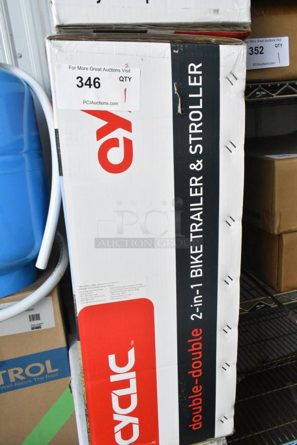 Brand new Cyclic Double 2-in-1 Bike Trailer & Stroller in box. Features include dual usage and sturdy construction.