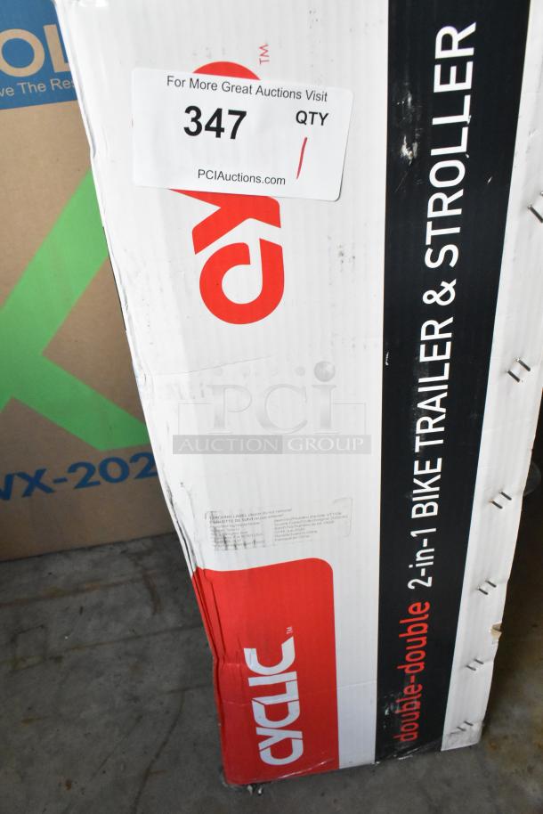 Brand new Cyclic Double 2-in-1 Bike Trailer & Stroller in box. Box labeling indicates model and condition.