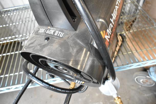 Mr Heater propane gas heater in fair condition, black, 30K-60K BTU marking, with hose attached.