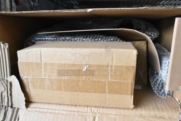 Brand new hitch bike rack in original packaging, bubble-wrapped, unopened condition, in a cardboard box.