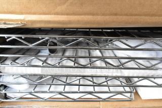 New wire shelf set in box, model B0B3CCQKHR, featuring durable chrome finish. Packaging is unopened.