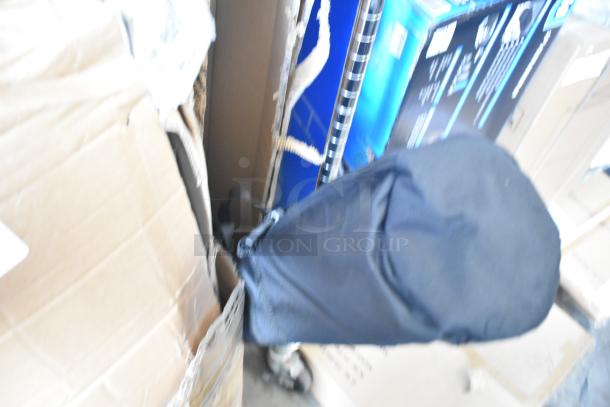 Brand new photography backdrop, packaged in black fabric cover, surrounded by boxes, no visible markings or labels.