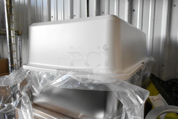 Two brand new cat litter boxes in original packaging, pristine condition, ready for use, with plastic wrapping visible.