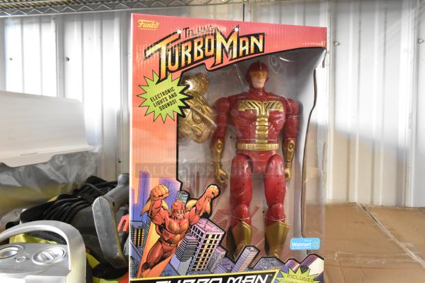 Funko Turbo Man figurine in original packaging, featuring electronic lights and sounds. Box intact with vibrant graphics.