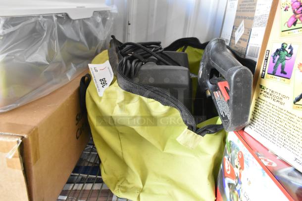 Ryobi 1600 PSI Electric Pressure Washer in a green carrying bag, with attached hose and nozzle, auction tag visible.
