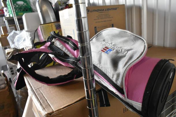 US Kids Golf pink and silver golf bag with three clubs, lightly used, features logo embroidery and adjustable straps.