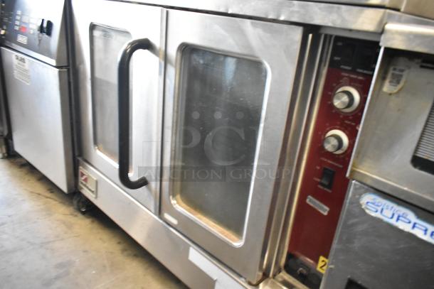Southbend stainless steel commercial convection oven with view-through doors and thermostatic controls on casters.