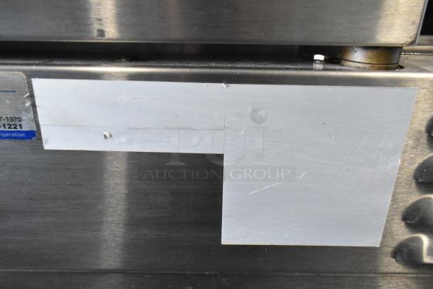 Close-up of Southbend stainless steel convection oven panel with markings. The surface shows wear.