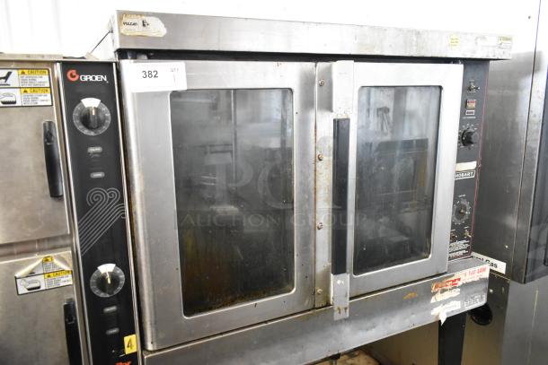 Hobart HGC5-10 stainless steel convection oven with view-through doors, metal racks, and thermostatic controls on metal legs.