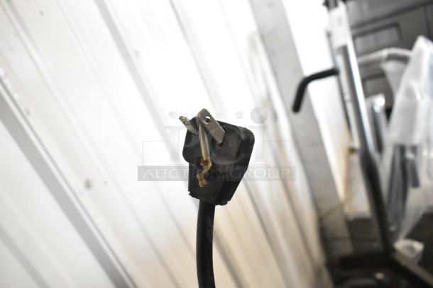 Close-up of a damaged power plug for Menumaster MDC182 stainless steel commercial microwave oven.