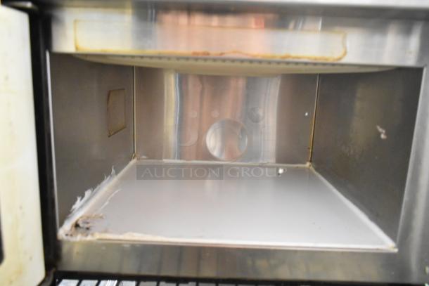 Menumaster MDC182 stainless steel commercial microwave oven interior, showing wear and discoloration. 208/230 volts, 1 phase.