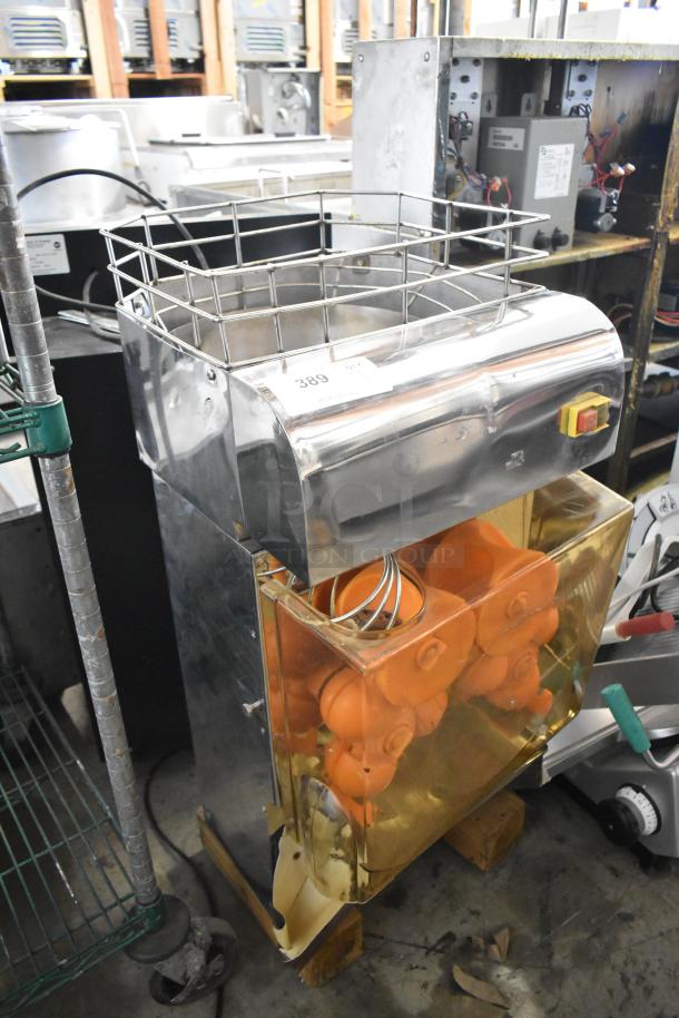 Commercial metal countertop citrus juicer, 115 volts, 1 phase, features visible wiring and an attached basket; sturdy condition.