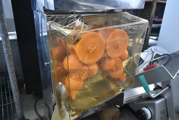 Metal commercial countertop citrus juicer, featuring orange squeezing components. 115 volts, 1 phase. Appears in used condition.