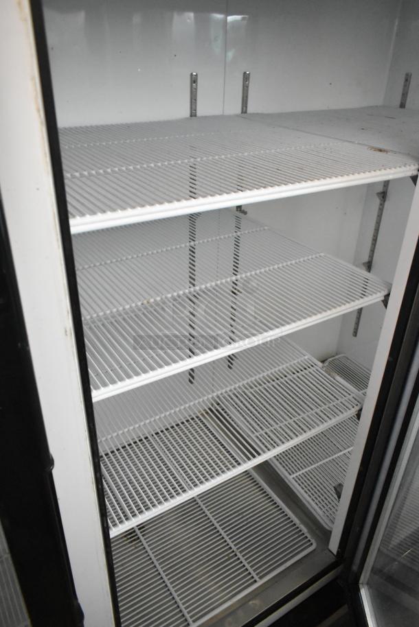 2018 Migali C-72FM commercial 3-door freezer with poly-coated racks, clean interior, suitable for high-volume storage.