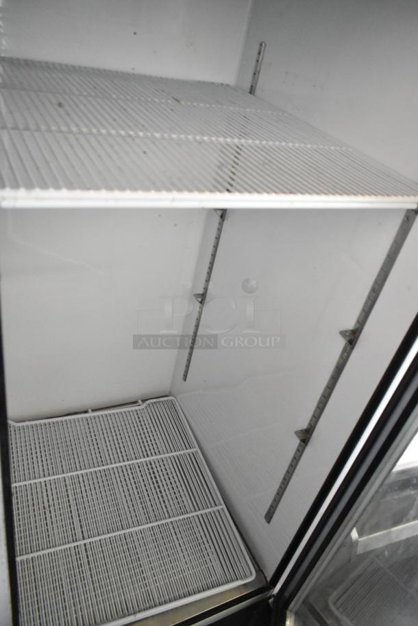 2018 Migali C-72FM commercial freezer interior, showing poly coated racks; clean condition, 3-door reach-in model.