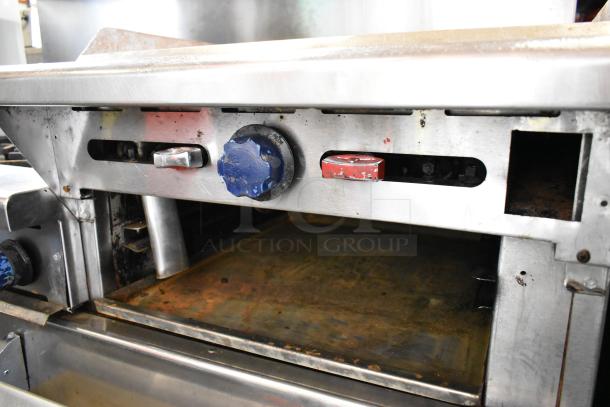 Imperial Stainless Steel 6-burner commercial gas range with right side griddle, two ovens, overshelf, and backsplash.