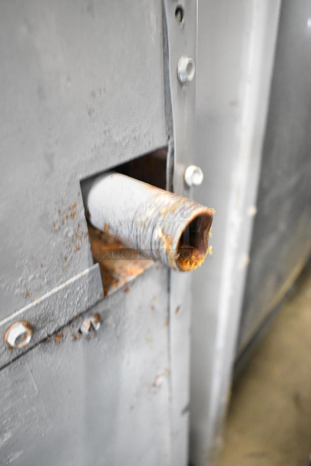 Imperial stainless steel range detail showing side vent with rust, highlighting wear.