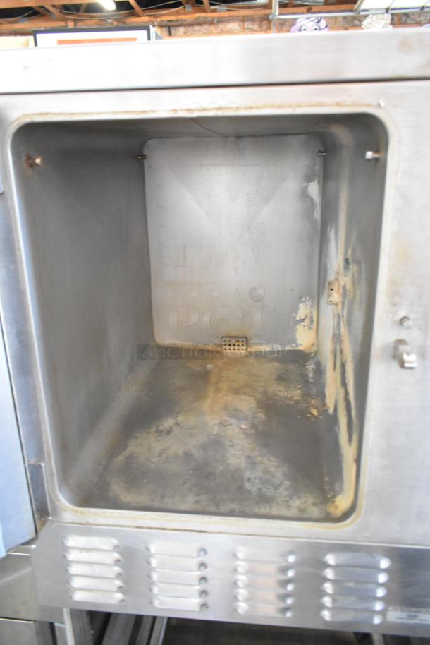 Hobart HC24EA5 stainless steel commercial steam cabinet interior, showing used condition with visible wear and discoloration.
