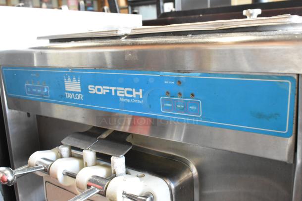 Taylor 754-27 stainless steel soft serve ice cream machine, 2 flavors with twist, on commercial casters. 208-230V, 1 phase.