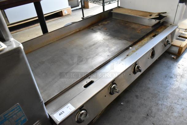 Stainless steel commercial countertop gas griddle, five control knobs, flat top, used condition with some surface wear, tag marked "403".