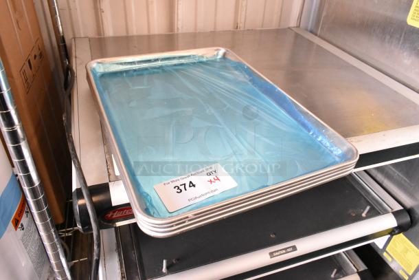 Brand new metal baking pans, set of 4. Each pan is covered in blue protective film. Condition: pristine. Lot label: "374 QTY x4."