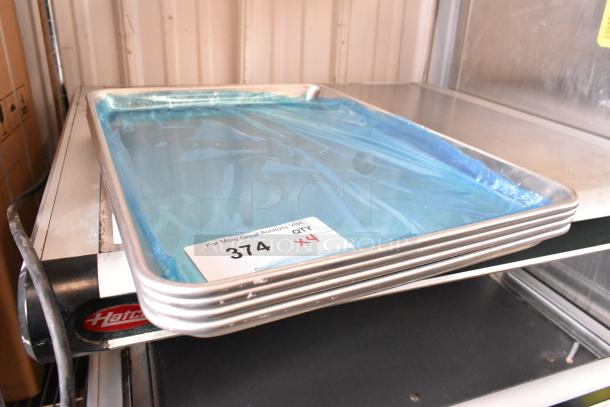 Four brand new metal baking pans stacked, label indicates quantity of four.