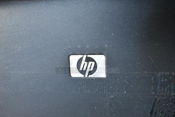 HP LaserJet P1606dn printer with visible logo, black finish. Ideal for countertop use. No visible wear or damage.