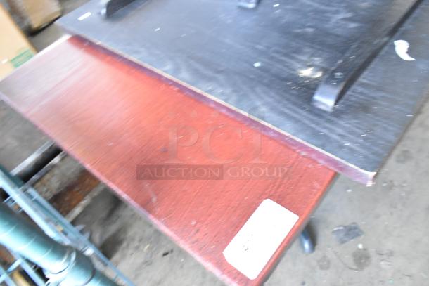 Six dining height tables with wood finish, visible wear, and corner markings. Auction includes all six tables, enhancing value.