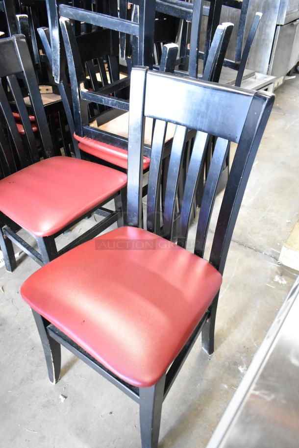 Set of 14 black dining height chairs with red seat cushions. Ideal for bulk bidding. Good condition.
