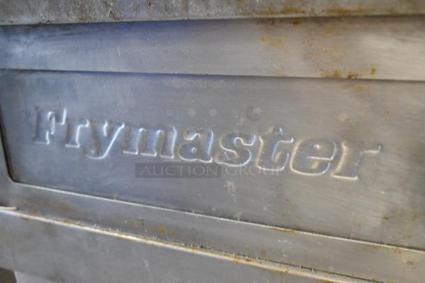 Frymaster FMPH255CSC commercial deep fat fryer, stainless steel, 2 bays, gas-powered, with filtration system and dumping station.