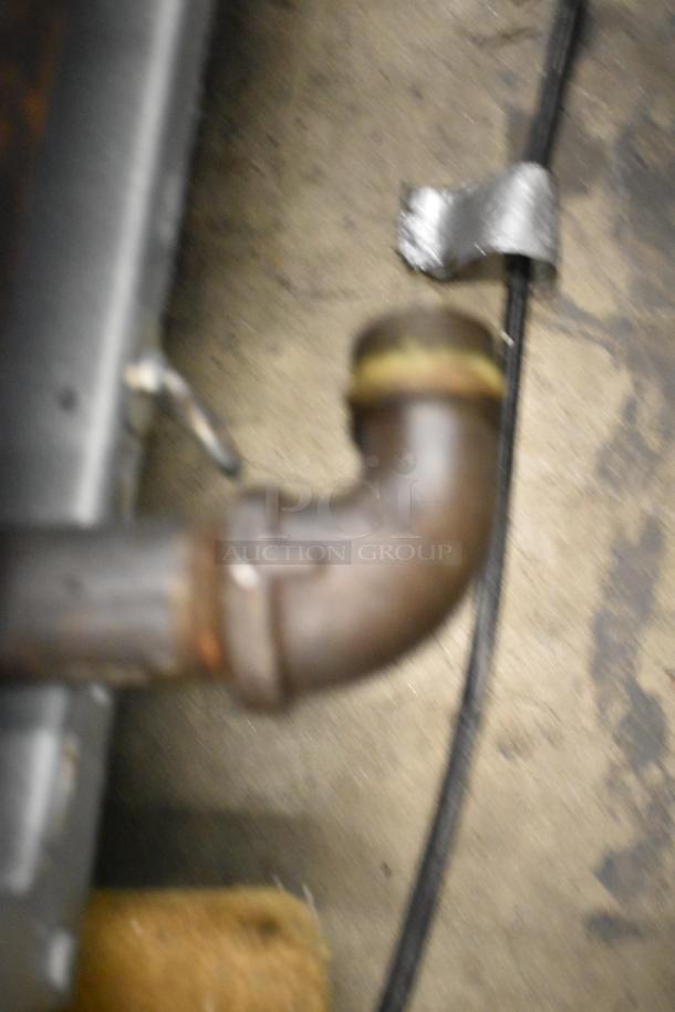 Blurry image of a metal pipe near a Frymaster FMPH255CSC commercial deep fat fryer.