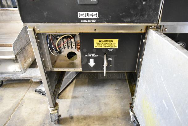 Giles EOF-24 stainless steel electric fryer, 2 bay, center dumping, on casters. 480V, 3 phase. Caution label visible.