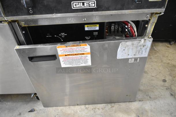 Giles EOF-24 stainless steel commercial fryer, dual bay with center dumping, 480V, 3-phase, on casters, visible caution labels.
