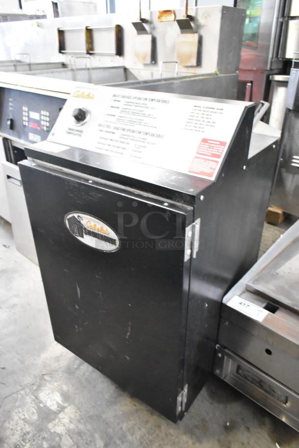 Pro Smoker N Roaster PK50PP commercial electric smoker, black metal, 120V, 1 phase, Cabela's logo visible, used condition.