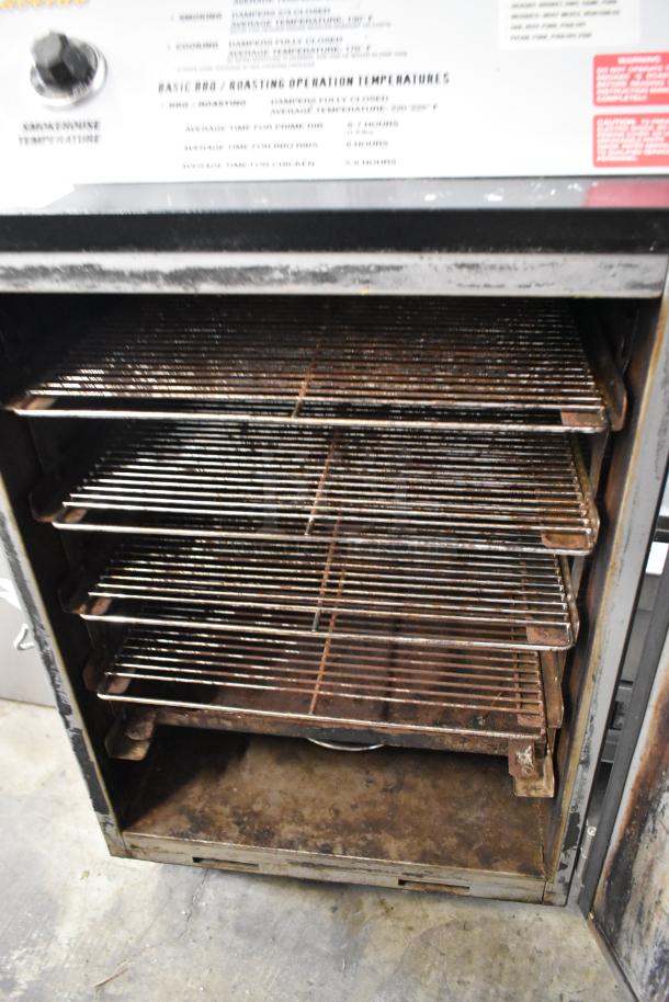 Pro Smoker N Roaster PK50PP metal commercial electric smoker, 120 volts, 1 phase, visible wear on interior racks.