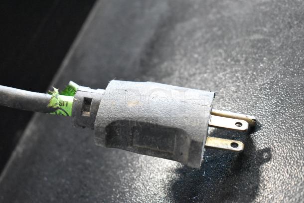 Close-up of a power plug for the Pro Smoker N Roaster PK50PP, highlighting its 120V connection.