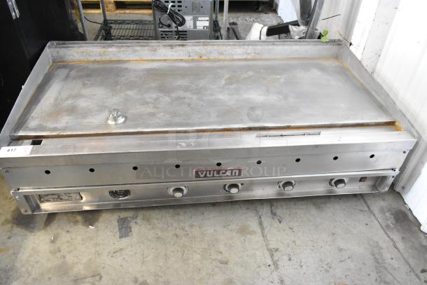 Vulcan stainless steel commercial flat top griddle with thermostatic controls, in used condition; visible wear but functional.
