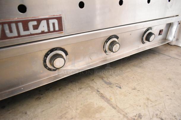 Vulcan stainless steel commercial griddle with thermostatic controls, featuring a flat top and visible brand logo.