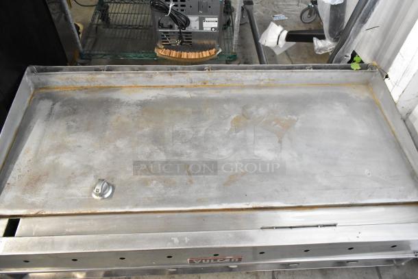 Vulcan stainless steel commercial flat top griddle with thermostatic controls, used condition, visible surface wear.