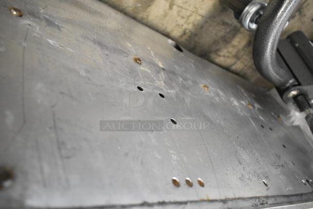 Vulcan stainless steel commercial flat top griddle with thermostatic controls, showing wear and surface scratches.