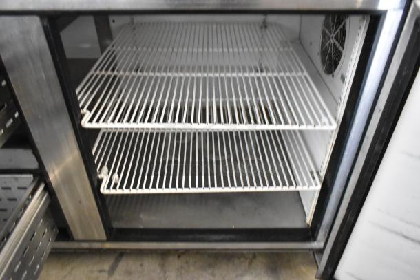 True TPP-67D-2 stainless steel pizza prep table, one door, two drawers, interior shelves visible, 115V, 1 Phase.