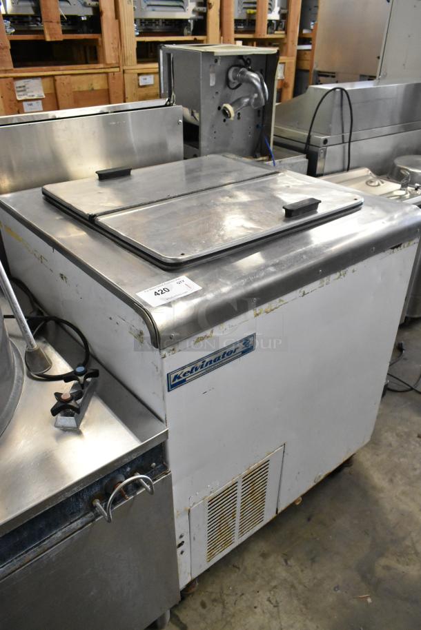 Kelvinator metal commercial chest freezer on casters, 115 volts, 1 phase. Visible wear on exterior.
